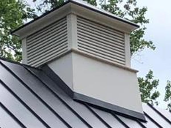 Metal standing-seam roof with a cupola against