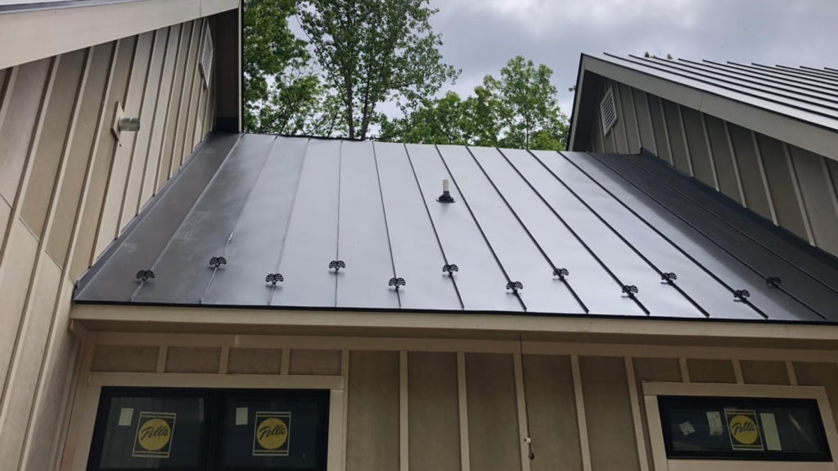 Commercial roof repair inspection on a flat roof
