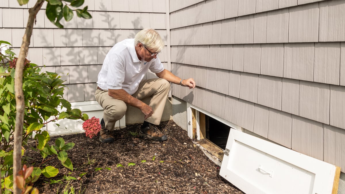 Homeowner checking an attic for leak signs