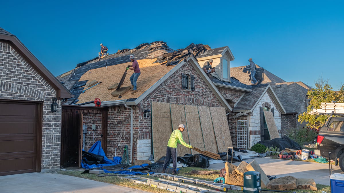 Homeowner and roofer reviewing a contract