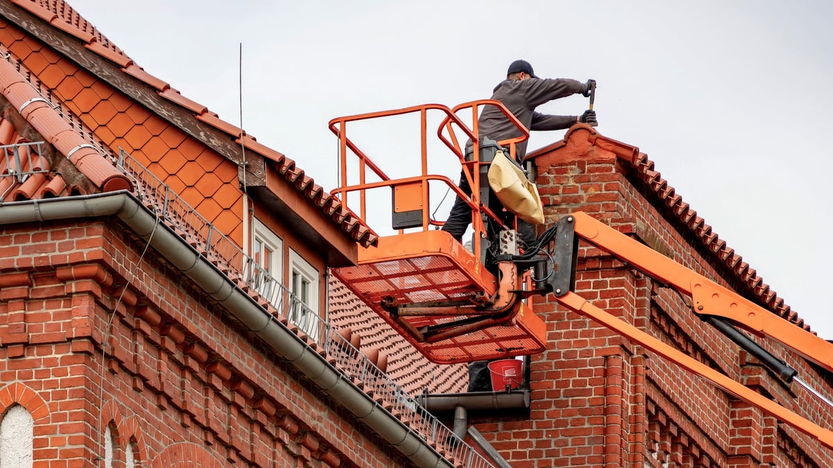 Homeowner and roofer reviewing roof damage
