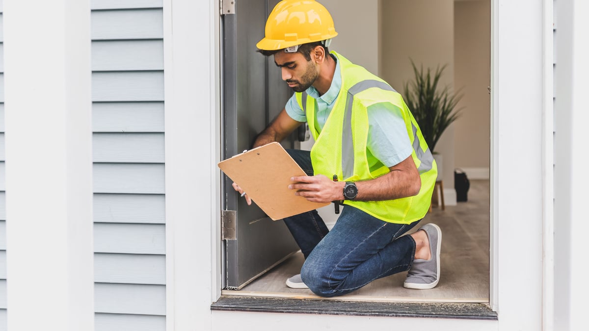 Inspector looking for roof leak signs