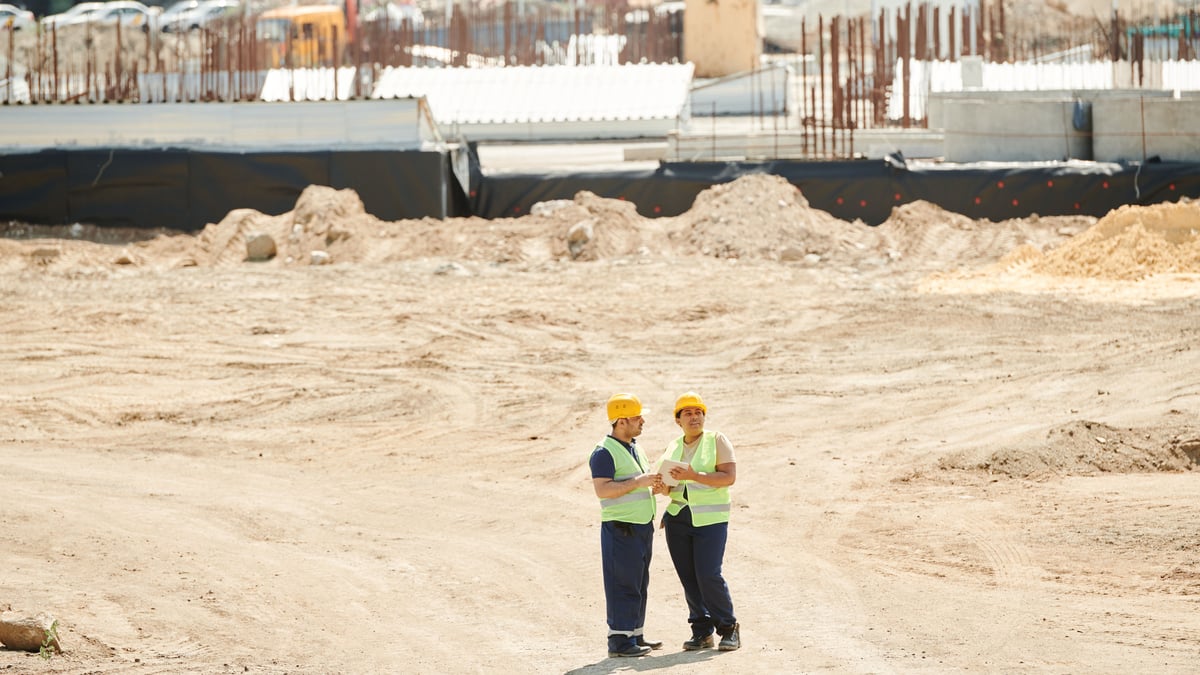 Roofer and builder discussing new roof schedule