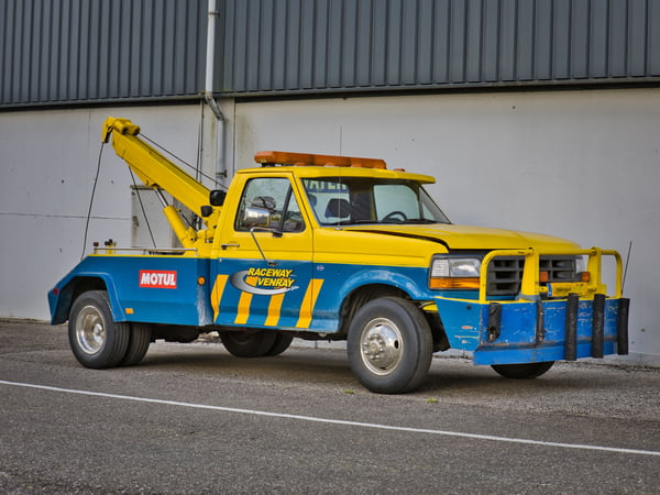 Yellow tow truck parked at Raceway Venray