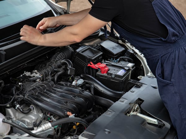 Mechanic performing maintenance on a car engine